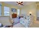 Inviting living room with ceiling fan, comfortable seating, and large windows at 1125 Deardon Dr, Venice, FL 34292