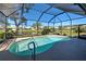 The screened-in pool area offers a picturesque view of the lush backyard and serene lake at 1125 Deardon Dr, Venice, FL 34292
