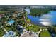 Stunning aerial view of community amenities, including a playground, lakes, swimming pool and lush landscaping at 11575 Okaloosa Dr, Venice, FL 34293