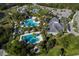 Aerial view of resort-style pool with cabanas and lush landscaping, creating a luxurious outdoor experience at 11575 Okaloosa Dr, Venice, FL 34293