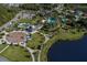 Aerial view of community pool, playground and lake surrounded by walking path at 11575 Okaloosa Dr, Venice, FL 34293