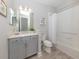 Bright bathroom featuring a modern vanity, white tile, and a shower-tub combination at 11575 Okaloosa Dr, Venice, FL 34293