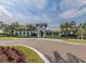 Stunning clubhouse with palm trees, beautiful architecture, and lush landscaping at 11575 Okaloosa Dr, Venice, FL 34293
