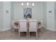 This dining room features wood-look tile floors, and a wood table surrounded by upholstered chairs at 11575 Okaloosa Dr, Venice, FL 34293