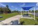 Well-maintained dog park with green grass, benches, and play structures, offering a fun space for pets at 11575 Okaloosa Dr, Venice, FL 34293