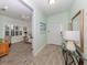 Light and airy foyer leads to a comfortable living room with wood-look flooring and neutral walls at 11575 Okaloosa Dr, Venice, FL 34293