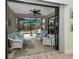 Seamless indoor-outdoor living, lanai with comfortable seating, ceiling fan, and lush views at 11575 Okaloosa Dr, Venice, FL 34293