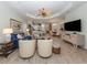 Open-concept living space with view of the kitchen and dining area, wood floors, and neutral decor at 11575 Okaloosa Dr, Venice, FL 34293