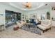 Bright living room with neutral paint, wood floors, and sliding glass doors to the lanai at 11575 Okaloosa Dr, Venice, FL 34293