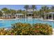 Large community pool with covered seating areas and manicured landscaping at 11575 Okaloosa Dr, Venice, FL 34293