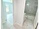 Bright bathroom featuring marble tile, a bathtub with shower, and white cabinetry at 12390 Talavera St, North Port, FL 34287
