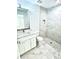 Modern bathroom with gray marble tile, a glass shower, and white vanity at 12390 Talavera St, North Port, FL 34287