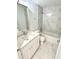 Modern bathroom with marble tile, a bathtub, and a sleek vanity at 12390 Talavera St, North Port, FL 34287