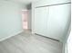 A clean, minimalist bedroom with a closet and light-colored wood flooring at 12390 Talavera St, North Port, FL 34287