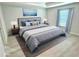 Bedroom with a large bed, curtains, lamps, and neutral furnishings at 12390 Talavera St, North Port, FL 34287