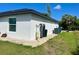 The side of the house with a water heater and equipment, with a clean and maintained exterior at 12390 Talavera St, North Port, FL 34287