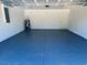 Spacious garage featuring painted floors, white walls, and an electric water heater at 12390 Talavera St, North Port, FL 34287