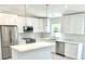 Bright kitchen features white cabinets, stainless steel appliances, and marble countertops at 12390 Talavera St, North Port, FL 34287