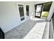 Bright open-air patio featuring French doors, screened-in porch, and marble flooring at 12390 Talavera St, North Port, FL 34287