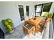 Covered patio with stylish dining set, marble floors, and outdoor access, perfect for entertaining at 12390 Talavera St, North Port, FL 34287