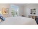 Bedroom showcasing a window with plantation shutters, natural light and a view to bring the outside in at 13016 Rinella St, Venice, FL 34293