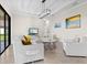 Bright living room with stylish white furniture, modern light fixture, and tiled floors at 13750 Portenza Ln, Venice, FL 34293