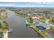 An aerial view of a waterfront community with canals, private docks, and lush tropical landscaping at 15688 Melport Cir, Port Charlotte, FL 33981