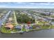 Aerial view of a waterfront home with a private boat dock and screened-in pool at 15688 Melport Cir, Port Charlotte, FL 33981