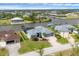 Aerial view of a waterfront home with lush landscaping, a pool, and a private boat dock at 15688 Melport Cir, Port Charlotte, FL 33981