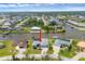 Aerial view of a waterfront home with a three car garage and private dock at 15688 Melport Cir, Port Charlotte, FL 33981