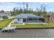 Aerial view of waterfront home with a private dock and screened pool, perfect for relaxation and boating at 15688 Melport Cir, Port Charlotte, FL 33981
