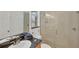 Bathroom features tile flooring, a double vanity, a mirror, a glass shower, and a toilet at 15688 Melport Cir, Port Charlotte, FL 33981