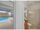 Bathroom featuring tile flooring, a vanity, a mirror, a toilet, and a glass shower. Pool view at 15688 Melport Cir, Port Charlotte, FL 33981