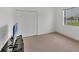 Bedroom features carpet, a window with view, and a closet with sliding doors at 15688 Melport Cir, Port Charlotte, FL 33981