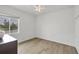 Bedroom features wood flooring, a ceiling fan, a window with a view, and a closet at 15688 Melport Cir, Port Charlotte, FL 33981