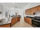 Bright open kitchen with stainless steel appliances and views into the living room at 15688 Melport Cir, Port Charlotte, FL 33981