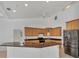 Well-lit open kitchen with stainless steel appliances, granite countertops, and spacious island at 15688 Melport Cir, Port Charlotte, FL 33981