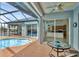 Outdoor dining and kitchen views from the screened lanai with a view of the pool and waterway at 15688 Melport Cir, Port Charlotte, FL 33981