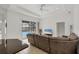 Living room with a sectional sofa and sliding doors leading to a screened pool area at 15688 Melport Cir, Port Charlotte, FL 33981