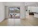Bright living area with tile floors and a sliding door leading to a screened pool area with seating at 15688 Melport Cir, Port Charlotte, FL 33981