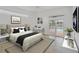 Well-lit main bedroom featuring a queen bed and a sliding door to the pool area at 15688 Melport Cir, Port Charlotte, FL 33981