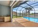 View of screened lanai featuring an outdoor wet bar overlooking the pool and canal at 15688 Melport Cir, Port Charlotte, FL 33981