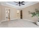 Main bedroom with tray ceiling, closet access, and an en-suite bath at 158 E Tampa Ave, Venice, FL 34285