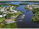 Scenic aerial view of waterfront community featuring private docks and lush surroundings near the water at 16 Nautical Dr, North Port, FL 34287
