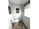 Bathroom with a toilet, a framed picture and a window with natural light at 16 Nautical Dr, North Port, FL 34287