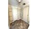 Bathroom with two entry doors, decorative wallpaper, and wood-look flooring at 16 Nautical Dr, North Port, FL 34287