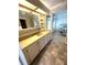 Bathroom vanity with marble countertops, drawers, sink and open view to the bedroom at 16 Nautical Dr, North Port, FL 34287