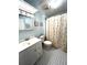 Well-lit bathroom with a vanity, toilet, and shower with decorative curtain at 16 Nautical Dr, North Port, FL 34287