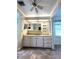 Bathroom vanity featuring a large mirror, storage, and decorative wallpaper at 16 Nautical Dr, North Port, FL 34287