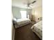 Well-lit bedroom features two twin beds, neutral walls, and a ceiling fan at 16 Nautical Dr, North Port, FL 34287